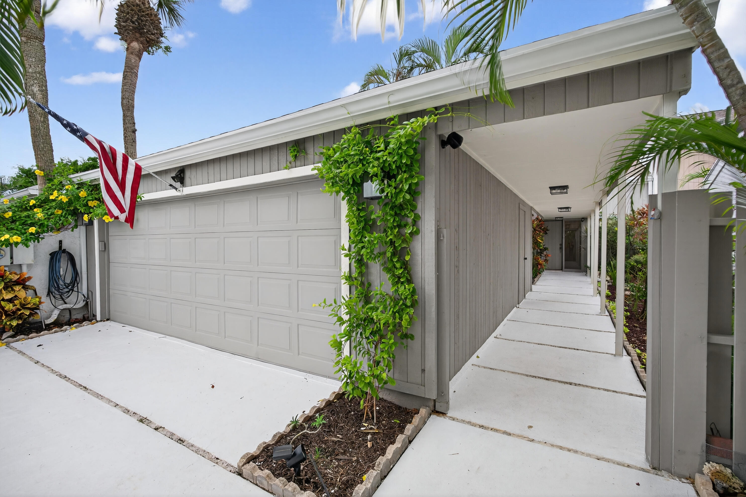 17145 Bay Street Jupiter, FL 33477 - Photo 5 of 43 a front view of a house with a garage