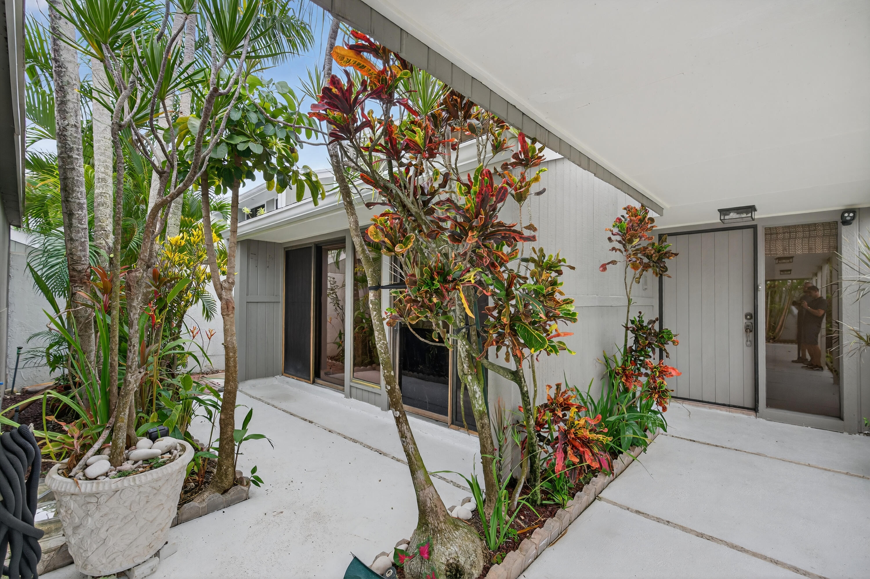 17145 Bay Street Jupiter, FL 33477 - Photo 6 of 43 a front view of a house with a porch