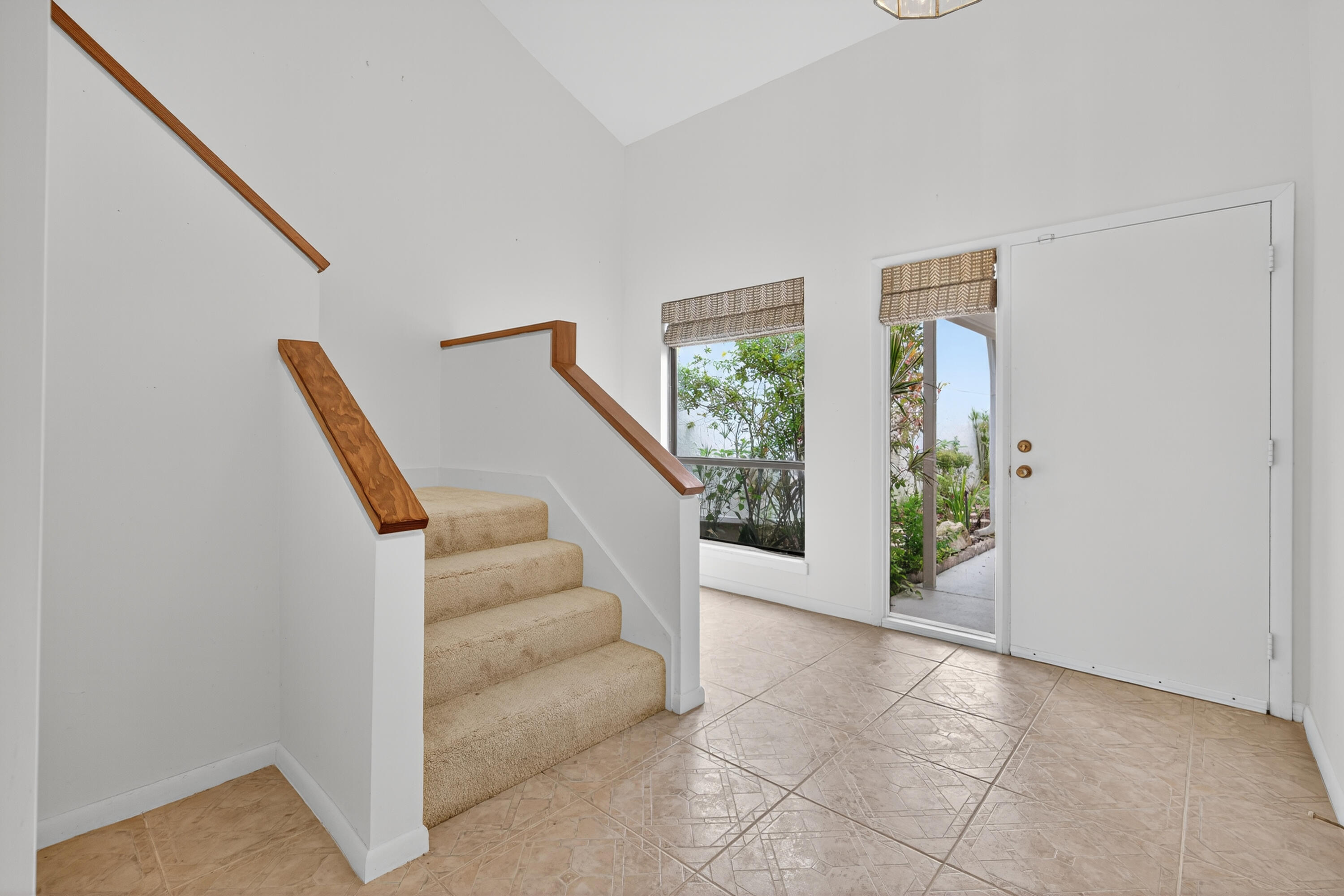 17145 Bay Street Jupiter, FL 33477 - Photo 8 of 43 a view of entryway with furniture and stairs