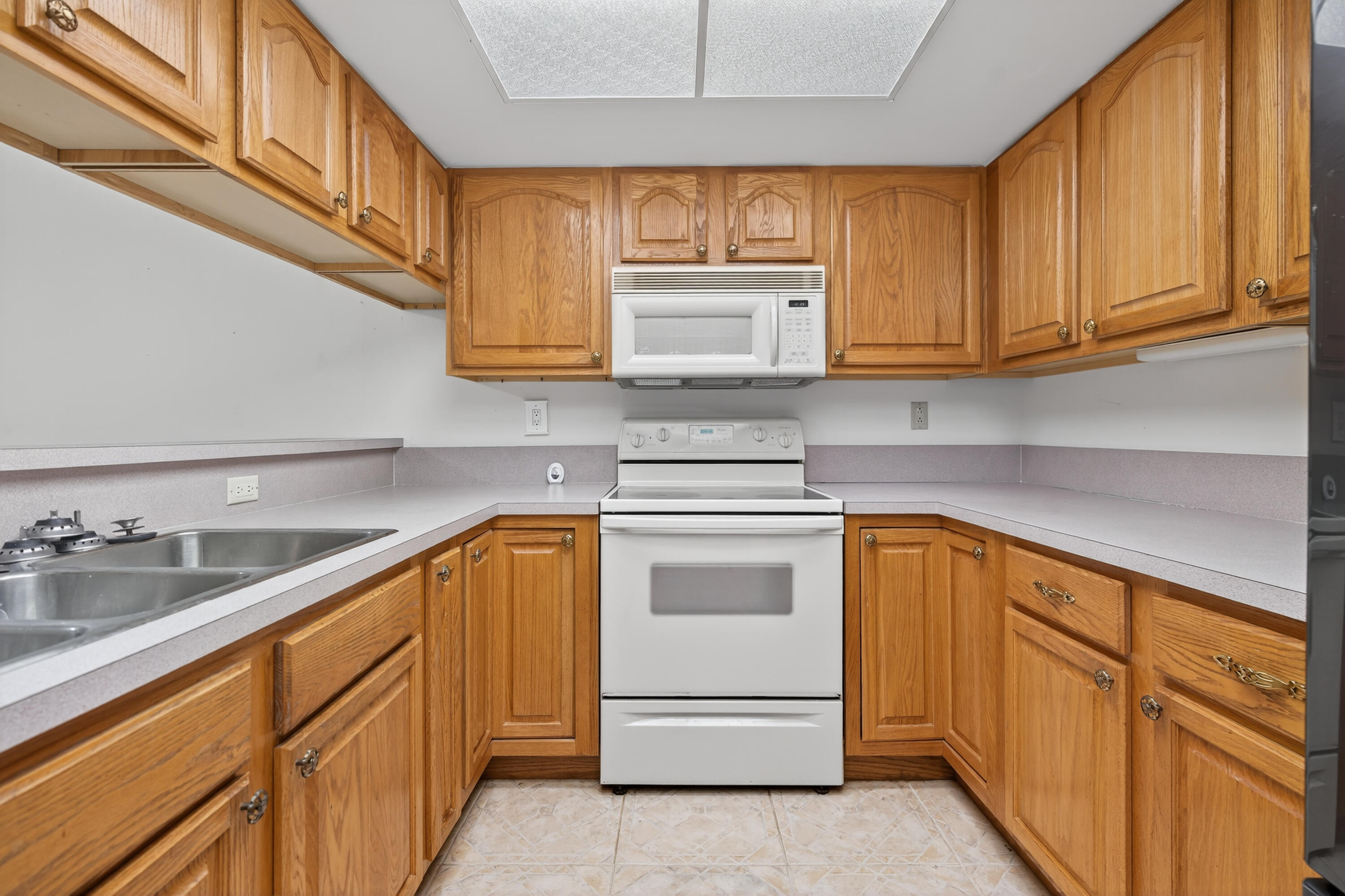 17145 Bay Street Jupiter, FL 33477 - Photo 10 of 43 a kitchen with granite countertop cabinets stainless steel appliances a sink and dishwasher