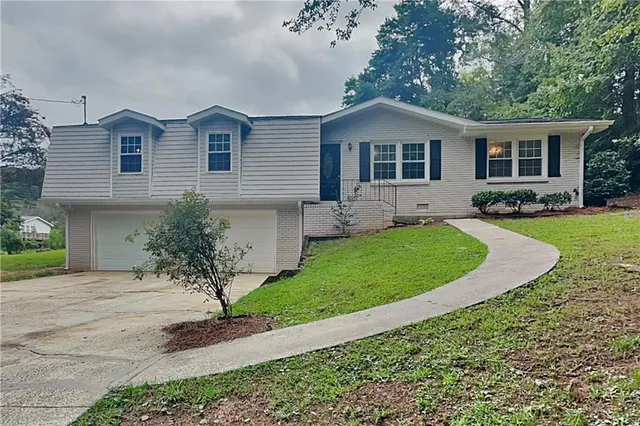 a front view of a house with a yard and porch