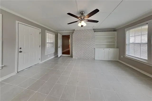 a view of a livingroom with a ceiling fan and window