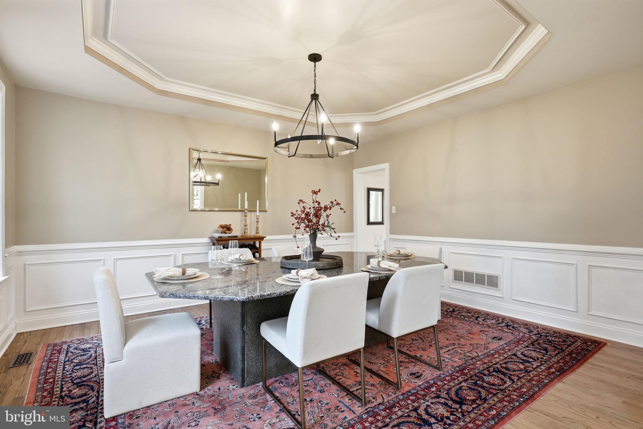 22 Springlea Lane Chester Springs, PA 19425 - Photo 24 of 80 a dining room with wooden floor a chandelier a wooden table and chairs