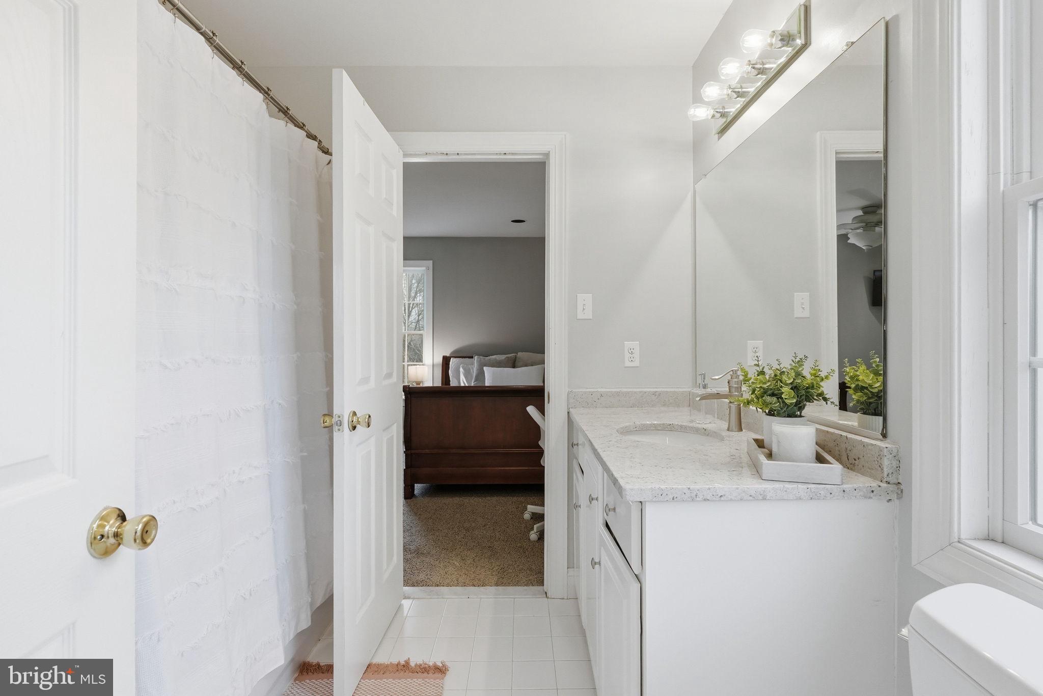 22 Springlea Lane Chester Springs, PA 19425 - Photo 59 of 80 a bathroom with a granite countertop sink and a mirror
