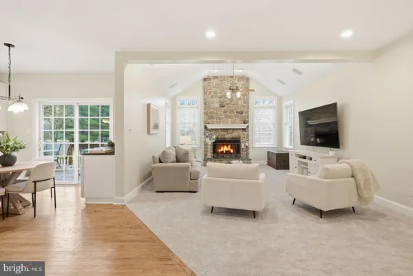 a living room with furniture and kitchen view