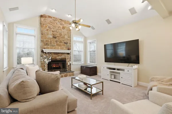a kitchen with stainless steel appliances kitchen island granite countertop a table chairs and a wooden cabinets