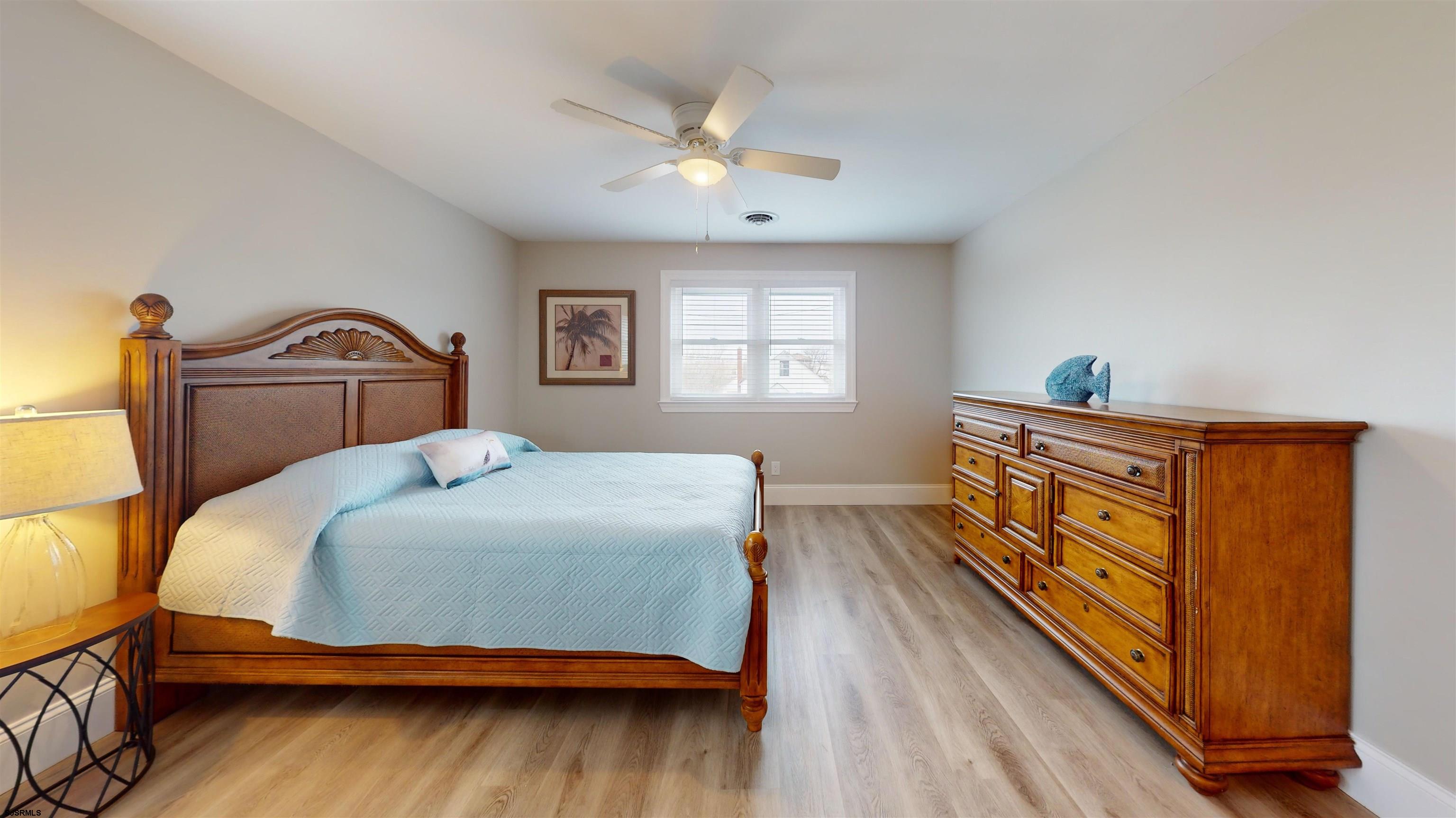 251 7th Street South, Unit 2 Brigantine, NJ 08203 - Photo 12 of 21 a bedroom with a bed and a dresser