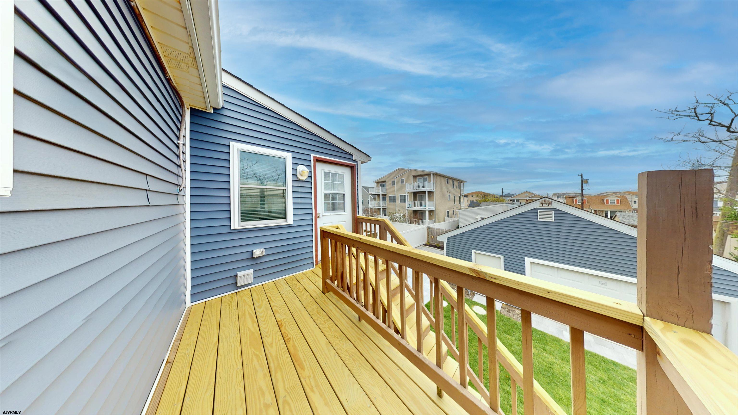 251 7th Street South, Unit 2 Brigantine, NJ 08203 - Photo 4 of 21 a view of balcony with wooden floor and fence