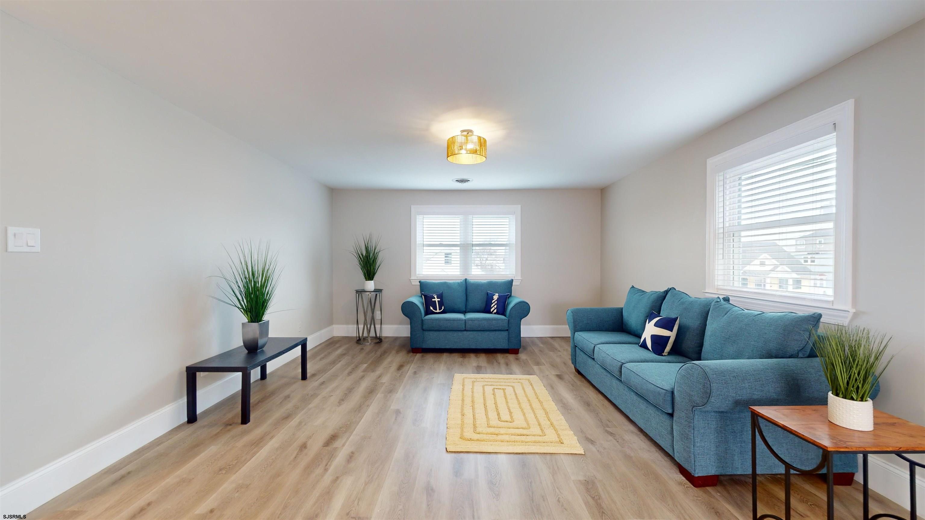 251 7th Street South, Unit 2 Brigantine, NJ 08203 - Photo 6 of 21 a living room with furniture and a potted plant