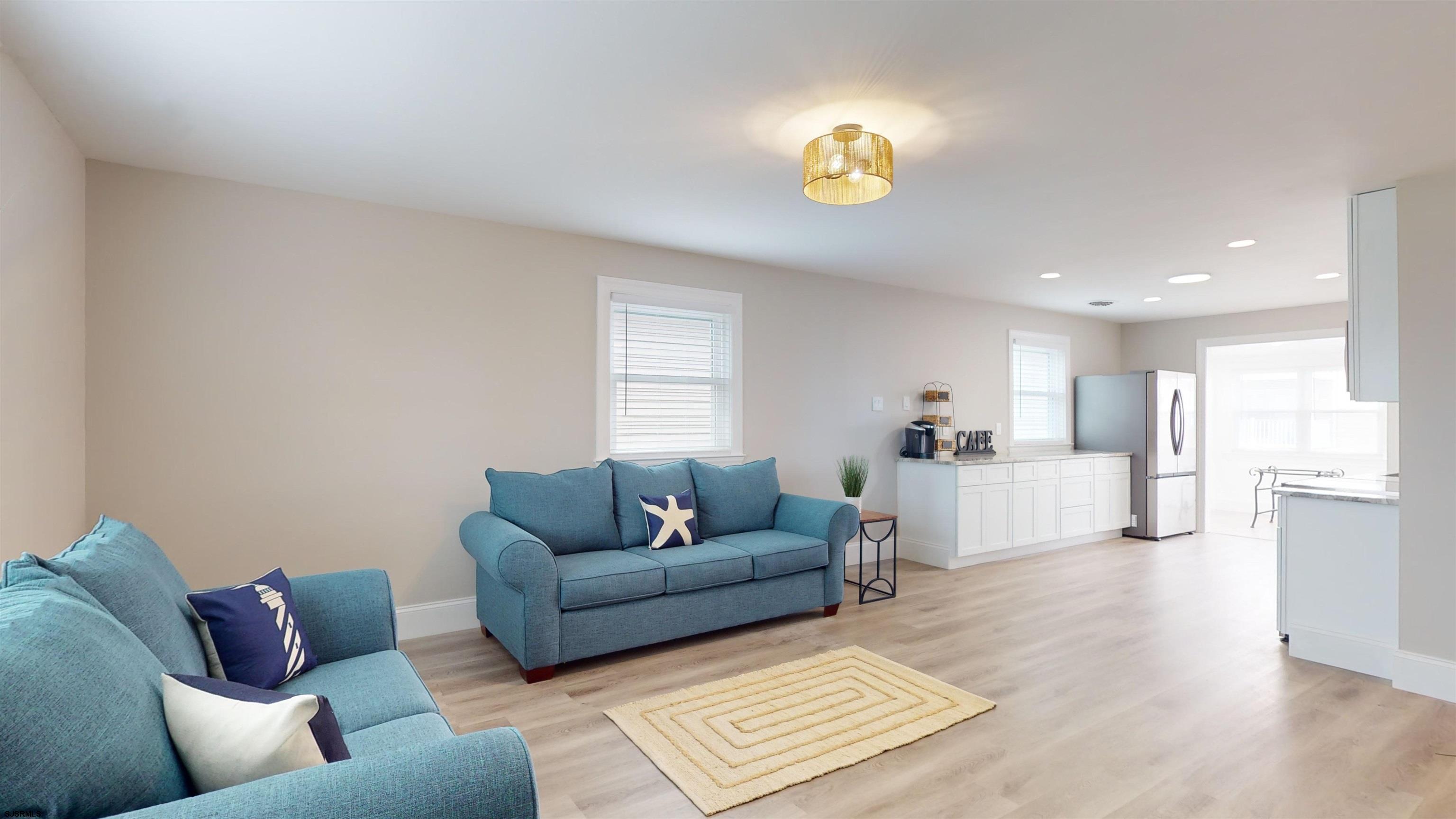 251 7th Street South, Unit 2 Brigantine, NJ 08203 - Photo 7 of 21 a living room with furniture and a wooden floor