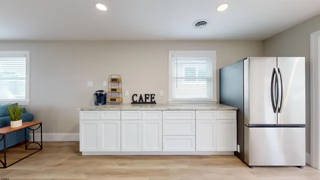 a kitchen with a refrigerator a stove a sink and a window