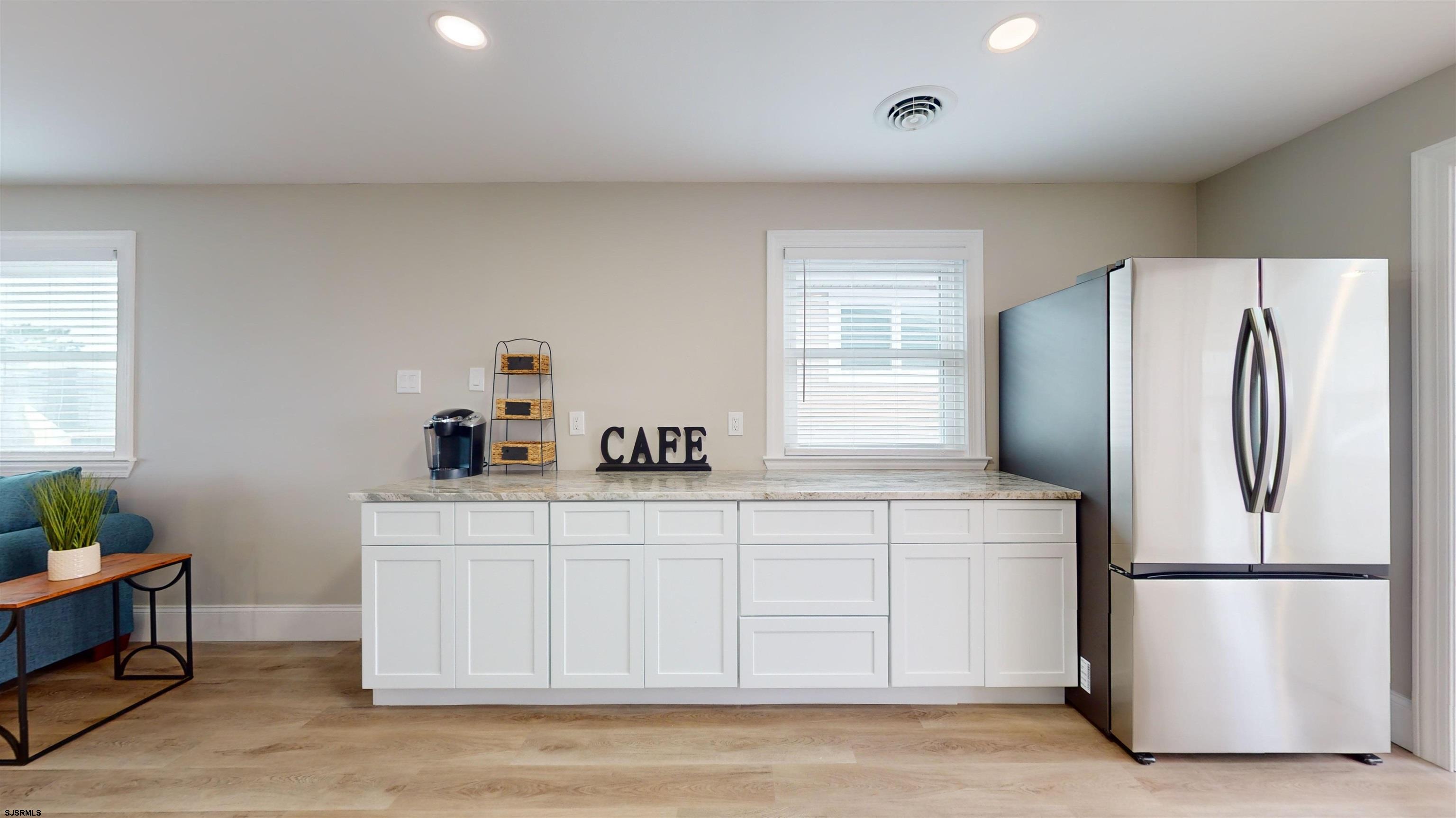 251 7th Street South, Unit 2 Brigantine, NJ 08203 - Photo 9 of 21 a kitchen with a refrigerator a stove a sink and a window