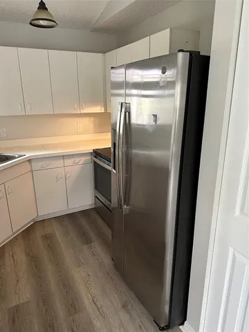 a kitchen with metallic refrigerator freezer and a dishwasher