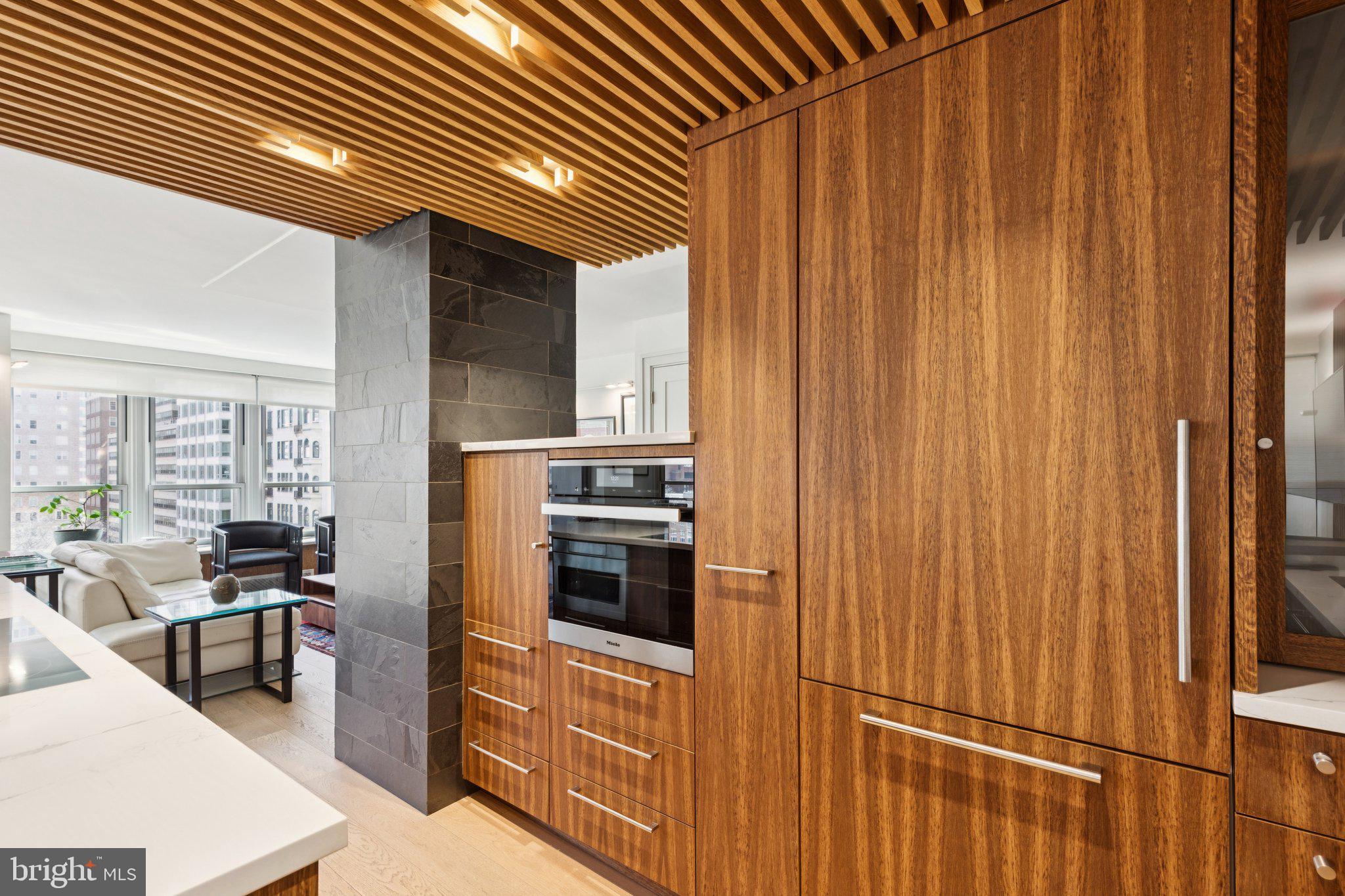 224 West Rittenhouse Square, Unit 1105 Philadelphia, PA 19103 - Photo 29 of 46 Sleek modern kitchen with warm wood tones.