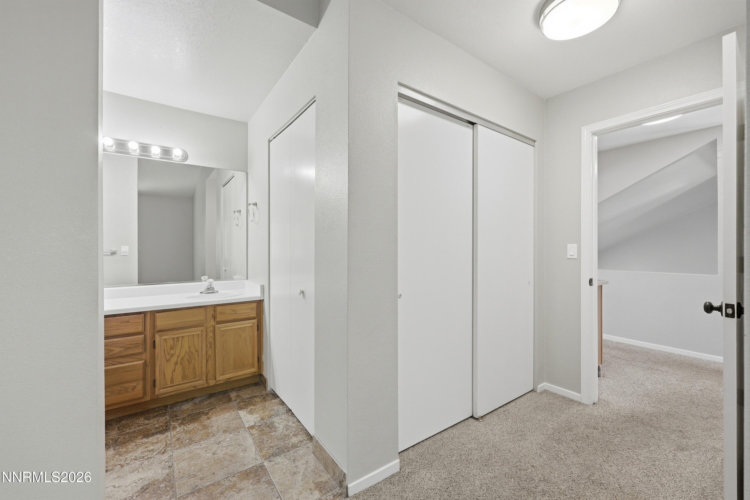 1899 Tuolumne Drive Reno, NV 89523 - Photo 21 of 44 a spacious bathroom with a mirror sink and double vanity