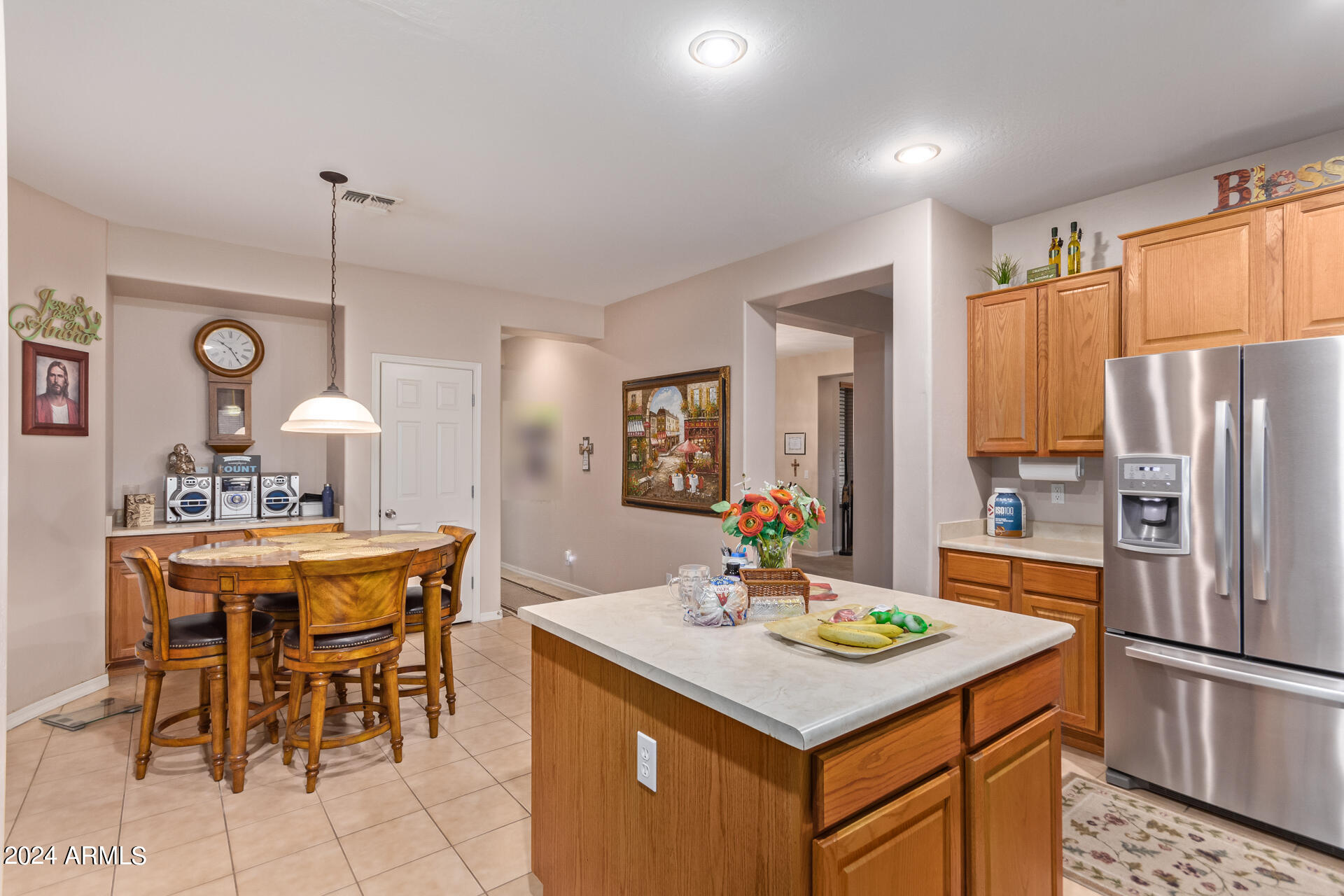 15224 West Redfield Road Surprise, AZ 85379 - Photo 14 of 28 a kitchen with a table chairs refrigerator and cabinets
