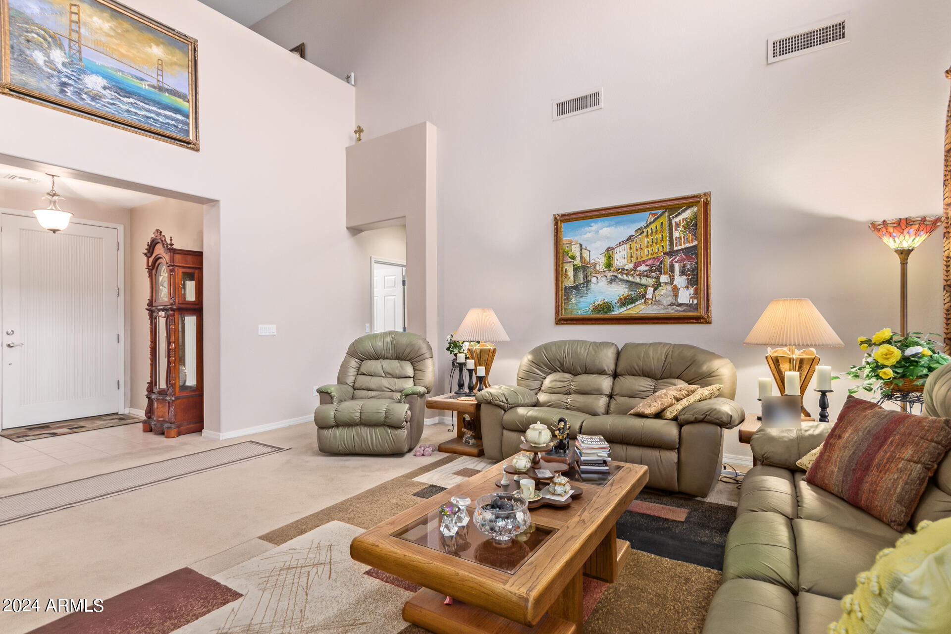 15224 West Redfield Road Surprise, AZ 85379 - Photo 6 of 28 a living room with furniture a lamp and a painting on the wall