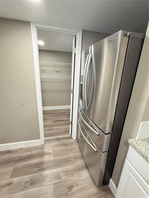 426 Becton Street Frostproof, FL 33843 - Photo 13 of 49 a view of a refrigerator in kitchen and an empty room