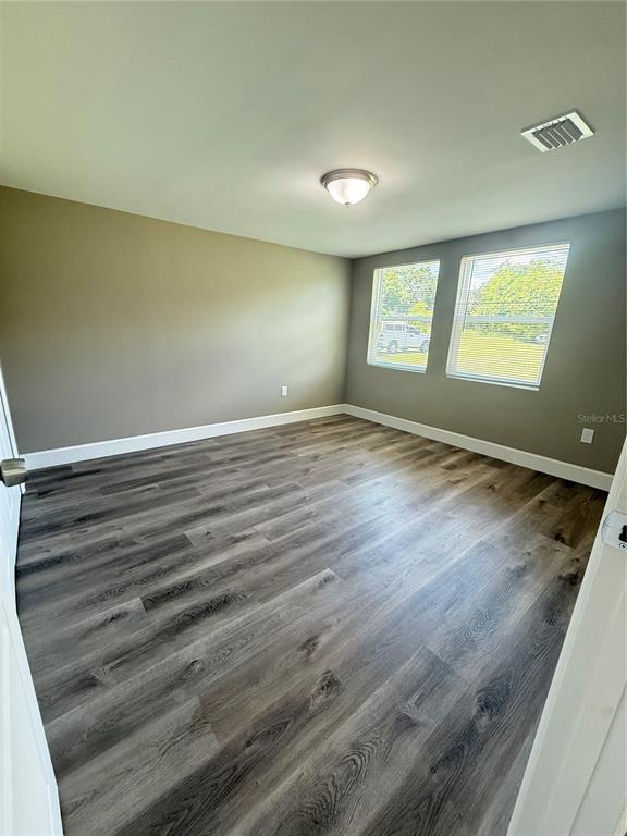 426 Becton Street Frostproof, FL 33843 - Photo 15 of 49 an empty room with wooden floor and windows