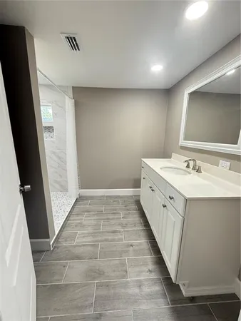 a bathroom with a double vanity sink and a mirror