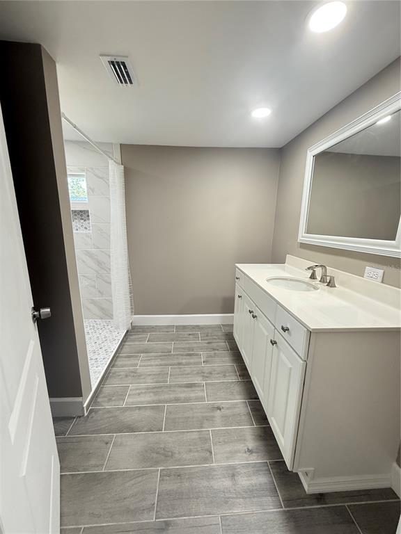 426 Becton Street Frostproof, FL 33843 - Photo 17 of 49 a bathroom with a double vanity sink and a mirror