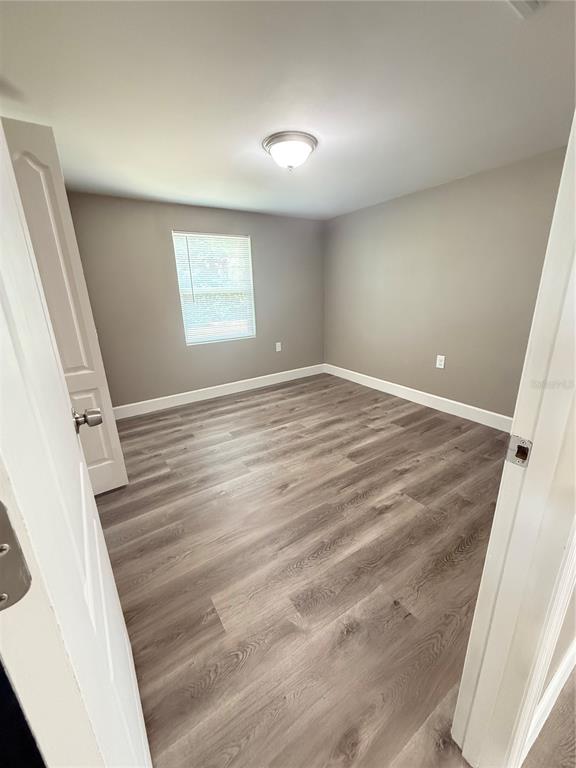 426 Becton Street Frostproof, FL 33843 - Photo 20 of 49 a view of empty room with wooden floor and fan