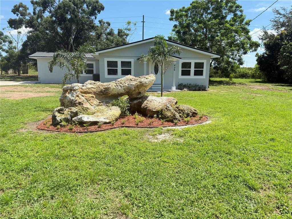 426 Becton Street Frostproof, FL 33843 - Photo 2 of 49 a front view of a house with a garden