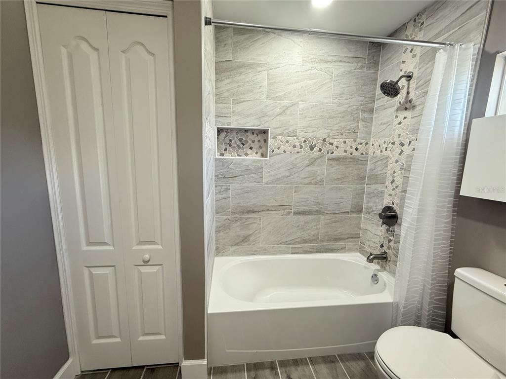 426 Becton Street Frostproof, FL 33843 - Photo 26 of 49 a bathroom with a toilet and a bathtub