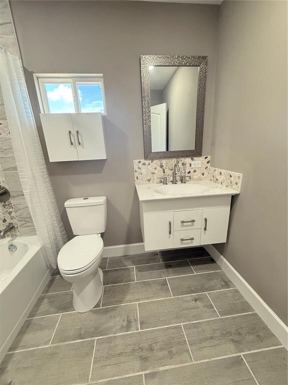 426 Becton Street Frostproof, FL 33843 - Photo 27 of 49 a bathroom with a sink toilet and mirror