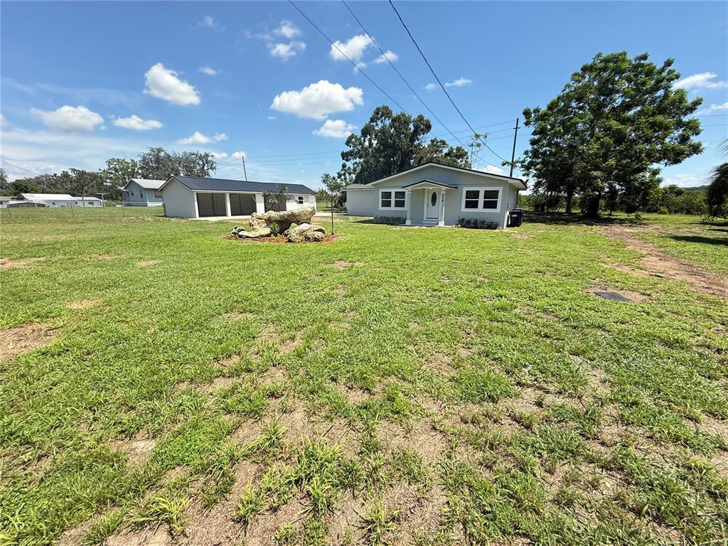 426 Becton Street Frostproof, FL 33843 - Photo 3 of 49 a front view of a house with garden