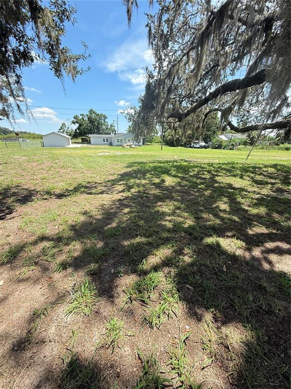 426 Becton Street Frostproof, FL 33843 - Photo 40 of 49 a view of a green field with an trees