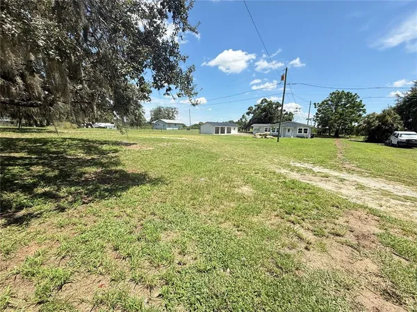 a swimming pool with outdoor seating and garden