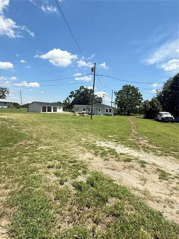 a view of a field with an ocean