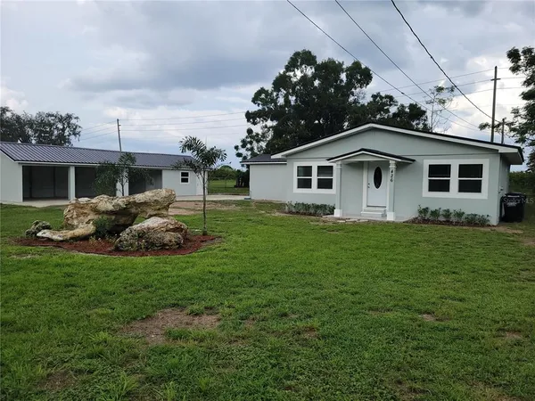 a front view of house with yard and green space