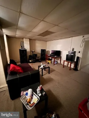 a bedroom with a bed and a gym machine