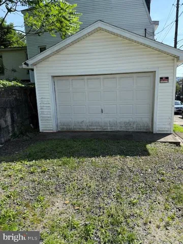 a view of backyard with barbeque grill and plants