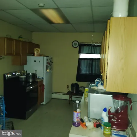 a view of a room that has a table and chairs in it