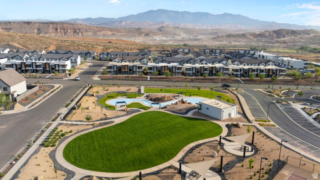 2133 Wolverine Way, Unit 2440 Washington, UT 84780 - Photo 32 of 39 Expansive community park featuring a large green space, aquatic area, and a building with an integrated shade structure