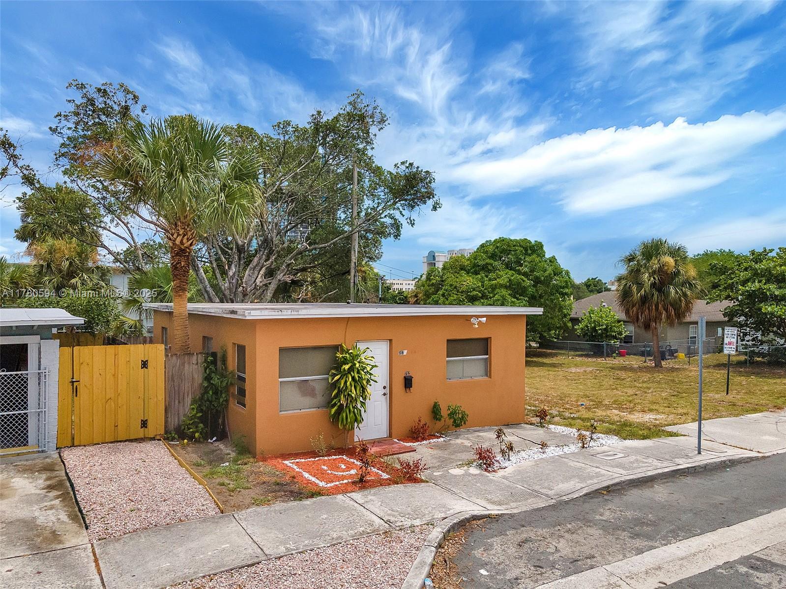 712 Division Avenue West Palm Beach, FL 33401 - Photo 14 of 37 a view of a house with pool lawn chairs under an umbrella