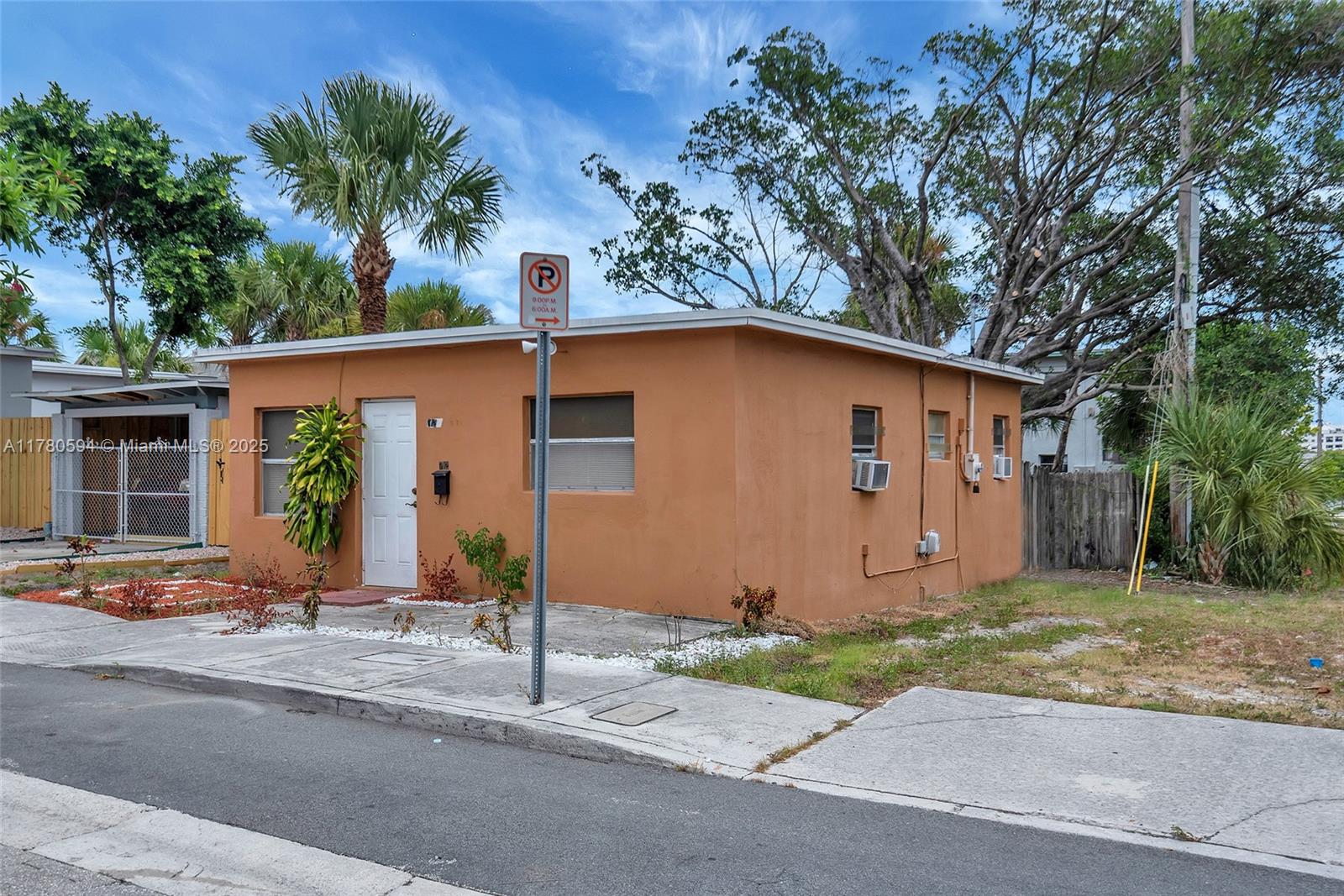 712 Division Avenue West Palm Beach, FL 33401 - Photo 16 of 37 a front view of a house with a yard and garage