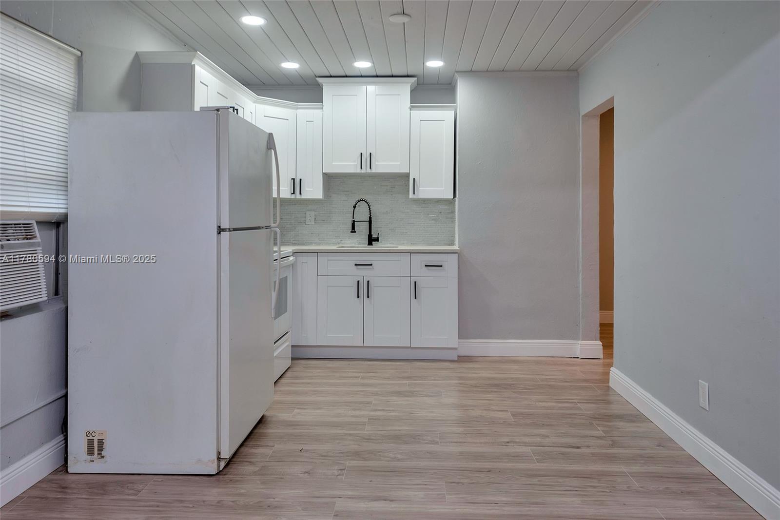 712 Division Avenue West Palm Beach, FL 33401 - Photo 19 of 37 a view of kitchen with wooden floor