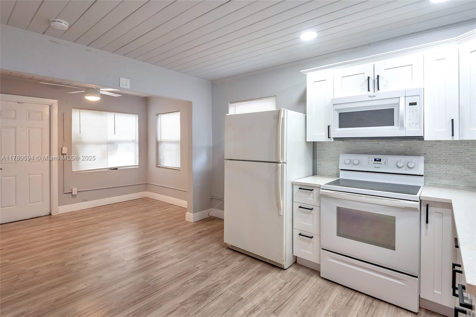 712 Division Avenue West Palm Beach, FL 33401 - Photo 25 of 37 a kitchen with a stove a refrigerator and a sink