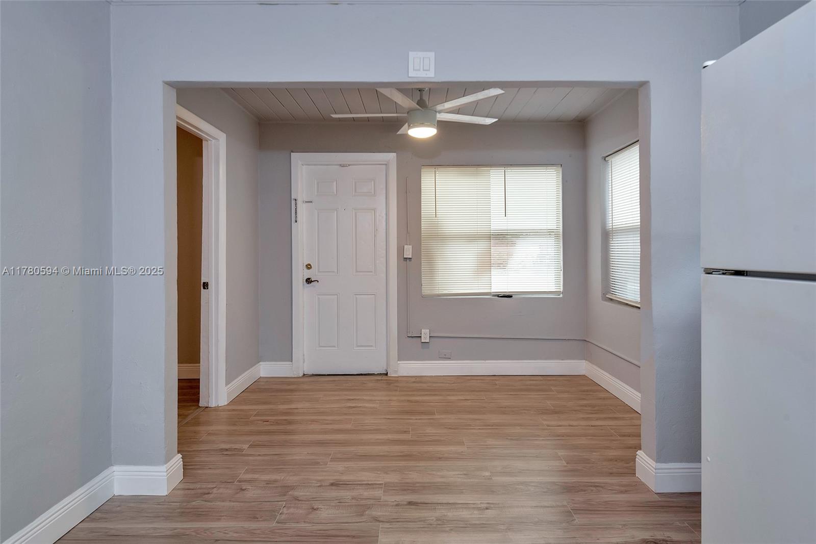 712 Division Avenue West Palm Beach, FL 33401 - Photo 26 of 37 a view of an empty room with window and wooden floor