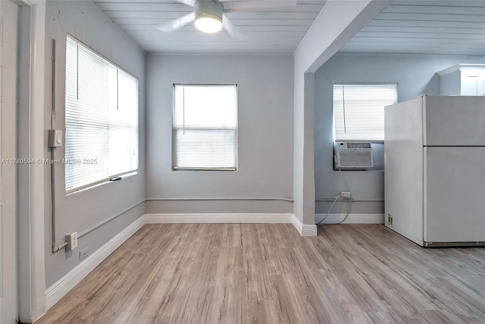 712 Division Avenue West Palm Beach, FL 33401 - Photo 3 of 37 a view of empty room with wooden floor and fan