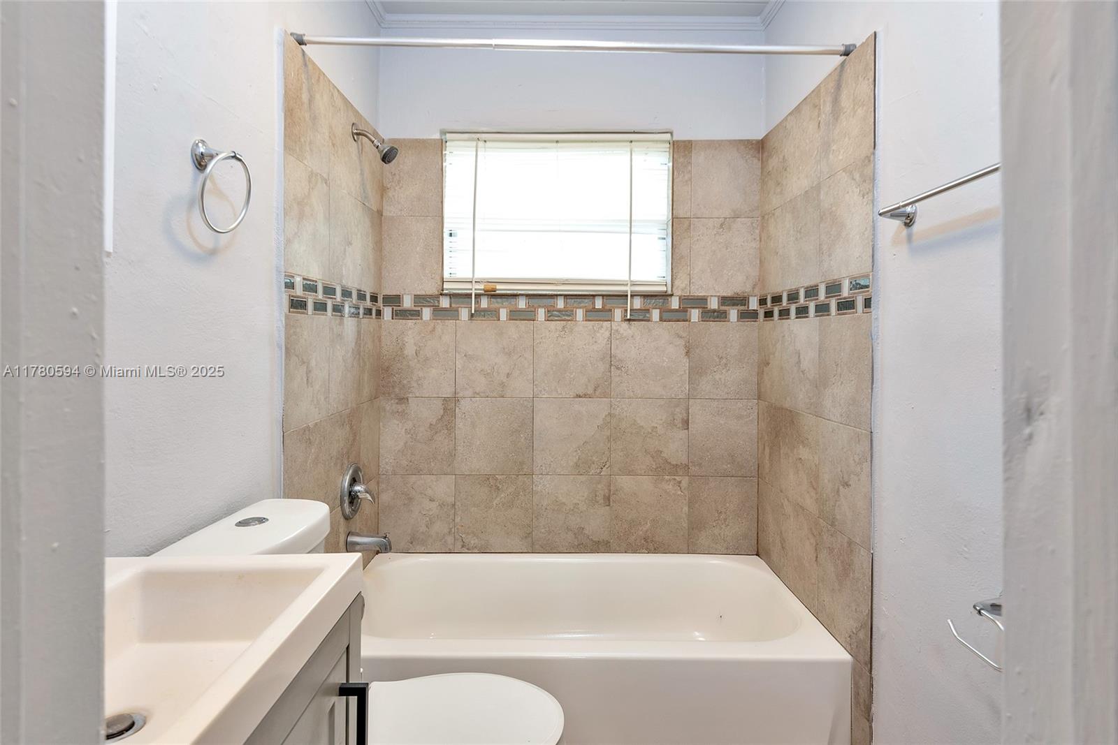 712 Division Avenue West Palm Beach, FL 33401 - Photo 31 of 37 a bathroom with a bathtub and a window