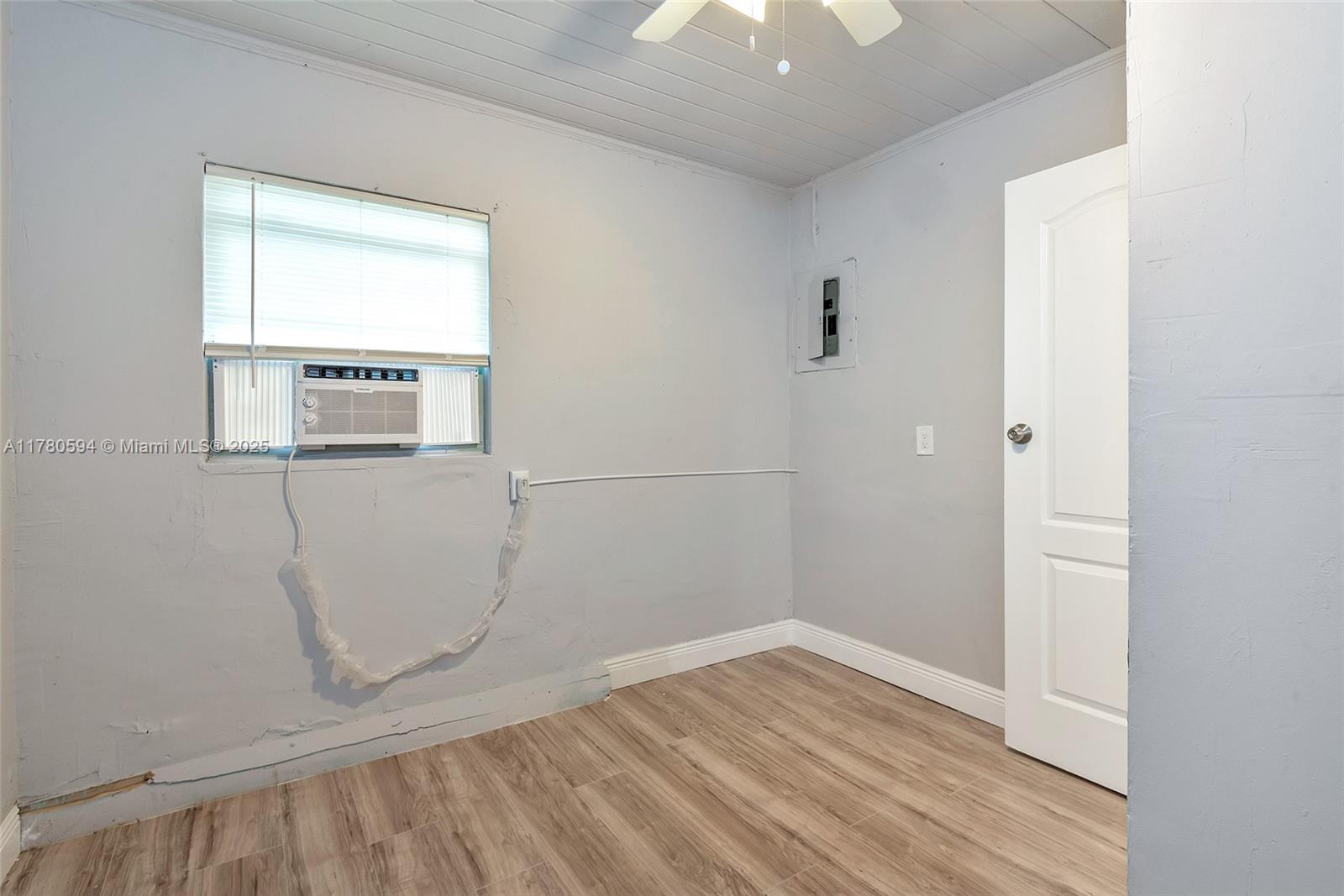 712 Division Avenue West Palm Beach, FL 33401 - Photo 36 of 37 an empty room with wooden floor and windows