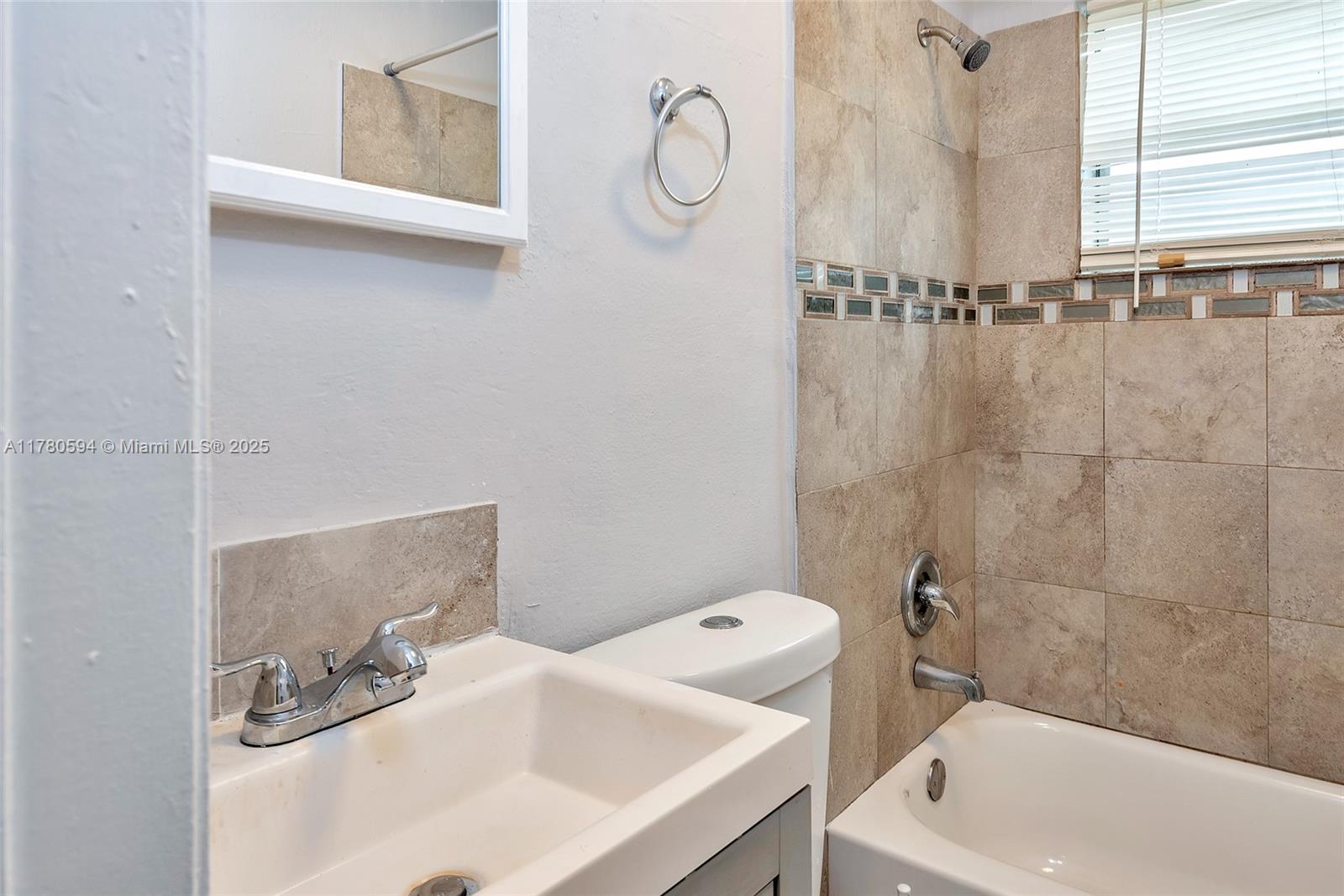 712 Division Avenue West Palm Beach, FL 33401 - Photo 4 of 37 a bathroom with a sink a toilet and shower