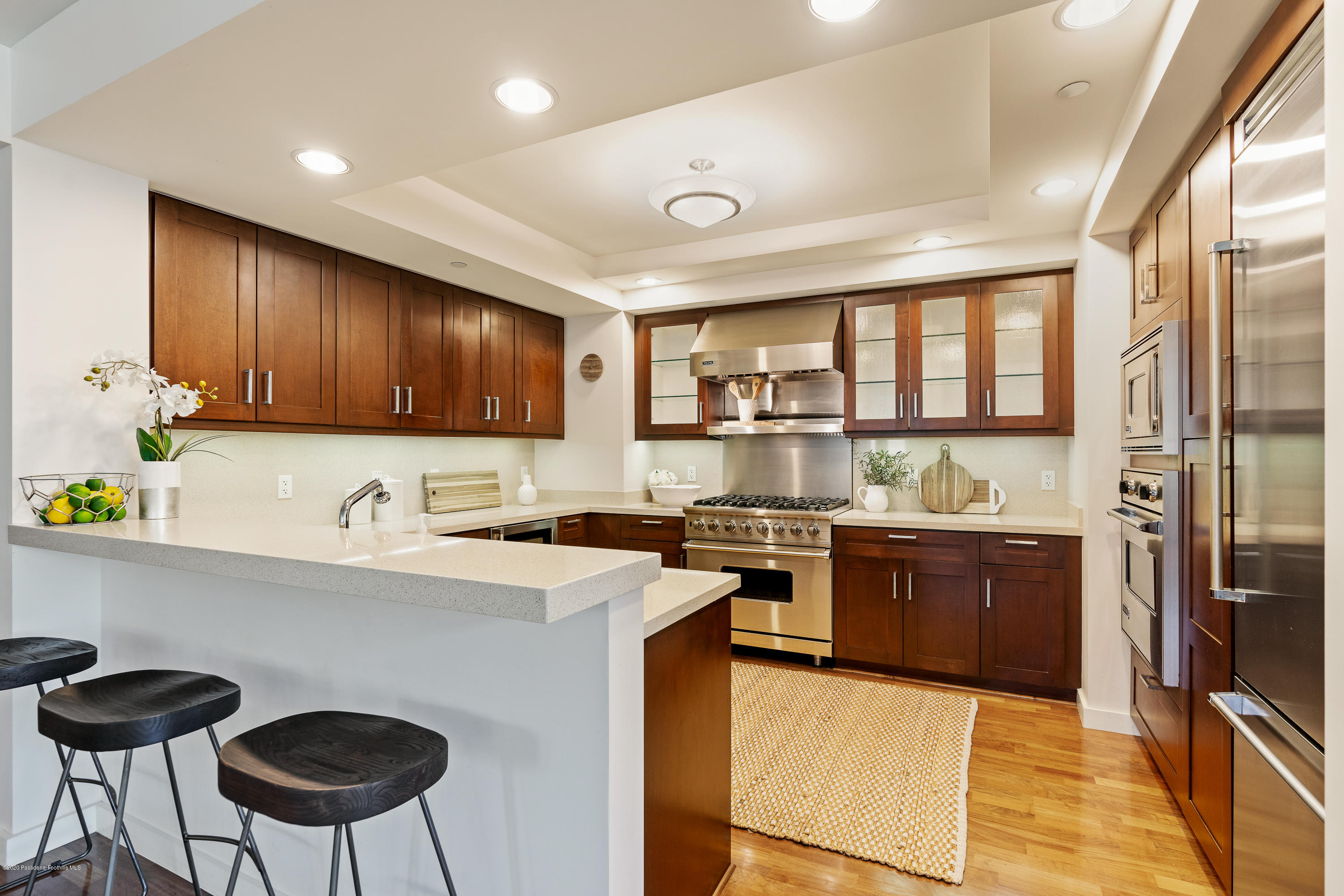 920 Granite Drive, Unit 309 Pasadena, CA 91101 - Photo 11 of 40 a kitchen with stainless steel appliances granite countertop a stove a sink dishwasher a refrigerator and a microwave oven with wooden floor