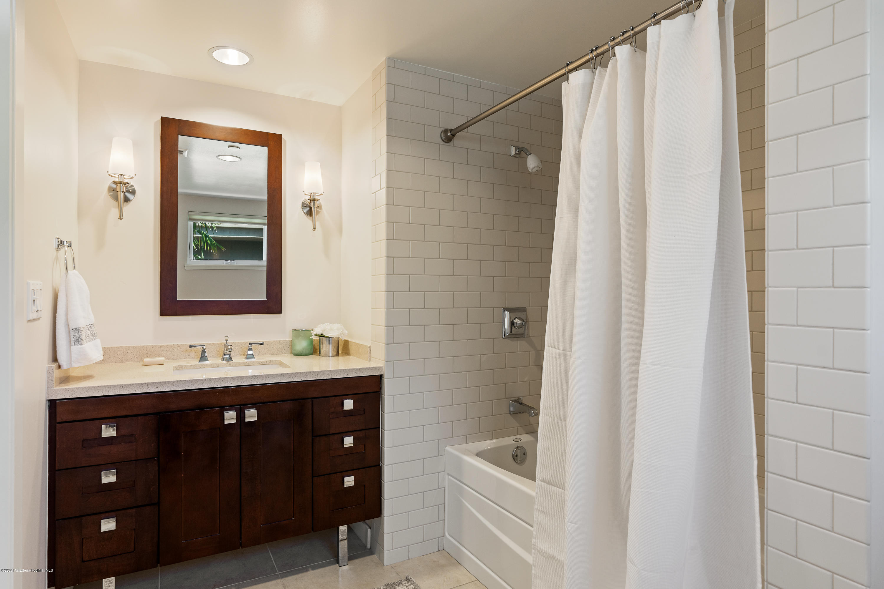 920 Granite Drive, Unit 309 Pasadena, CA 91101 - Photo 20 of 40 a bathroom with a double vanity sink a large mirror and a bathtub