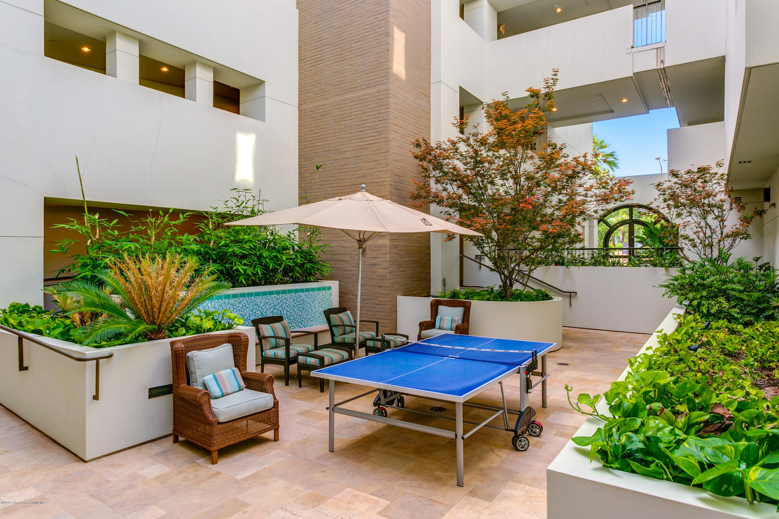 920 Granite Drive, Unit 309 Pasadena, CA 91101 - Photo 33 of 40 a view of a chairs and table in backyard